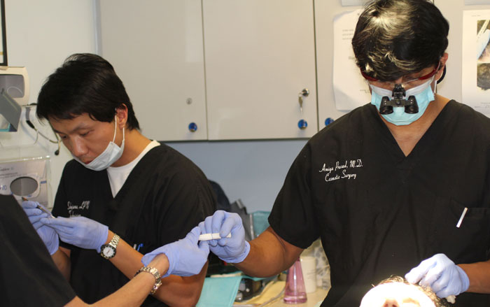 Dr. Amiya Prasad and staff performing hair transplant