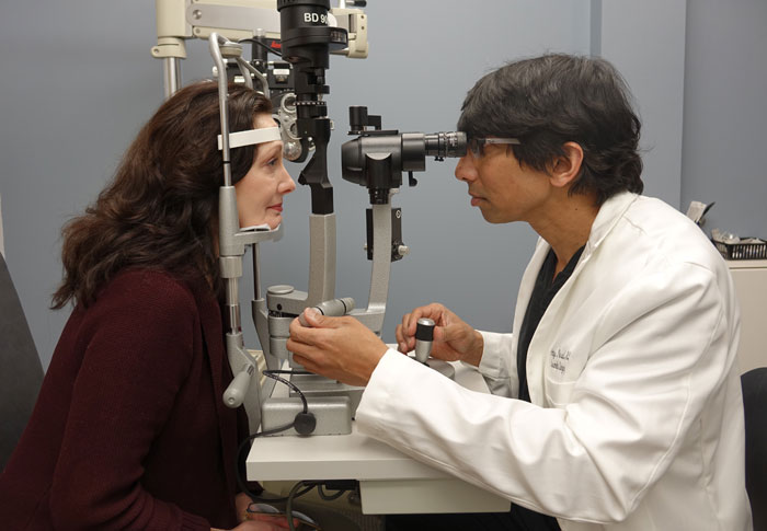 Dr. Amiya Prasad doing slit lamp exam with a patient